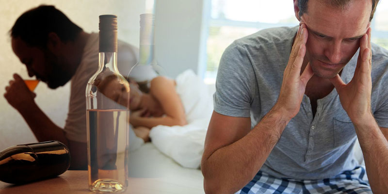 a man disturbed due to his high alcohol intake while his unsatisfied sad wife lying in bed